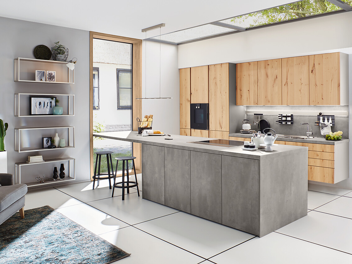 Een verfijnde combinatie van echte hout en betonlook: Deze greeploze designkeuken met bar straalt moderne elegantie uit. Ballerina, bekend om zijn duurzame en aanpasbare keukens, biedt hier een meesterwerk van vakmanschap. Zuordnung: Stil Moderne keukens, Planungsart keukenblok